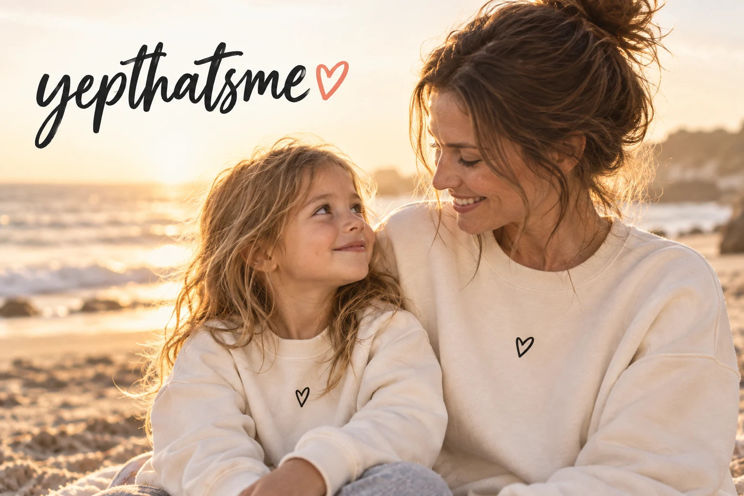 YepThatsMe: a mother and daughter sharing a smile in matching cream sweatshirts at the beach